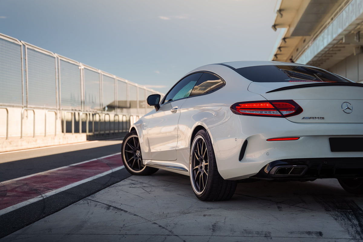 White Mercedes-AMG C63 coupé on track